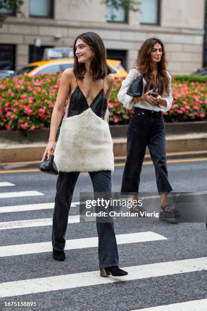 Guest wears faux fur top, denim jeans outside Khaite on September 09, 2023 in New York City.