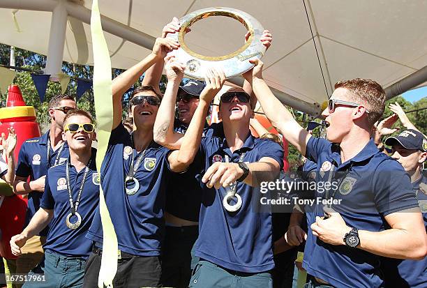 Mariners players L to R Michael McGlinchey, Trent Sainsbury, Mitchell Duke and Oliver Bozanic hold the A-League trophy during the Central Coast...