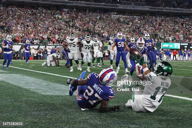 Wide receiver Garrett Wilson of the New York Jets catches a three-yard touchdown reception against cornerback Tre'Davious White of the Buffalo Bills...