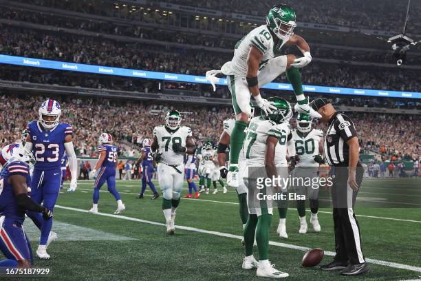Wide receiver Allen Lazard of the New York Jets leaps over Garrett Wilson after Wilson caught a three-yard touchdown reception against the Buffalo...