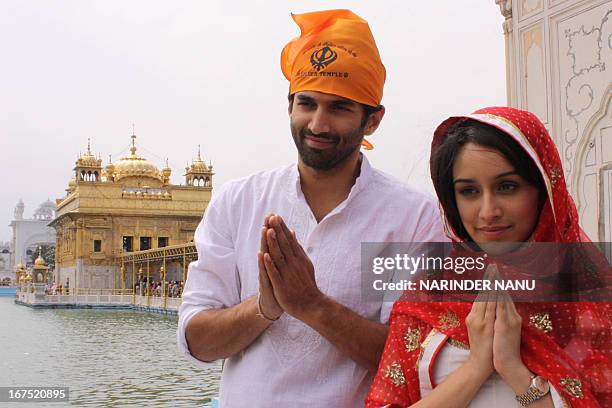 Indian Bollywood actor Aditya Roy Kapoor and actress Shraddha Kapoor pose for a photo near the Sikh Shrine the Golden temple in Amritsar on April 26,...