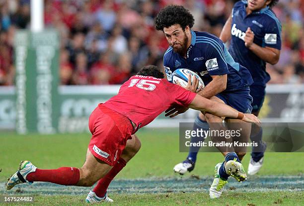 Rene Ranger of the Blues takes on the defence during the round 11 Super Rugby match between the Reds and the Blues at Suncorp Stadium on April 26,...