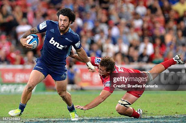 Rene Ranger of the Blues pushes away from the defence during the round 11 Super Rugby match between the Reds and the Blues at Suncorp Stadium on...