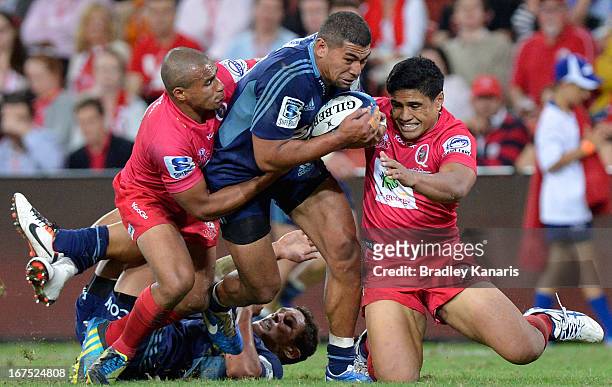 Charles Piutau of the Blues attempts to break through the defence during the round 11 Super Rugby match between the Reds and the Blues at Suncorp...