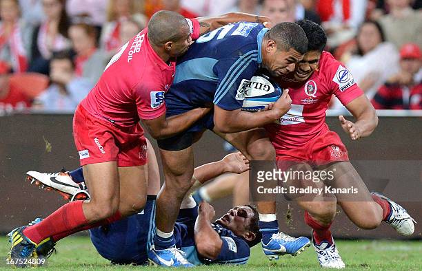 Charles Piutau of the Blues attempts to break through the defence during the round 11 Super Rugby match between the Reds and the Blues at Suncorp...