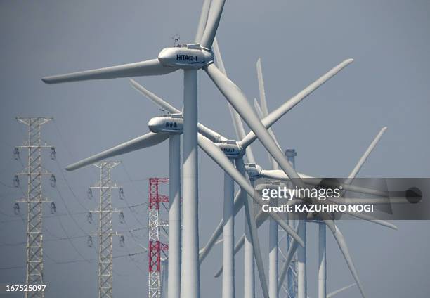 Wind turbines generate electricity at the seaside in Kamisu city, Ibaraki prefecture about 110 kms east of Tokyo on April 26, 2013. As of April 2013,...