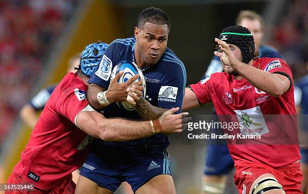 Frank Halai of the Blues takes on the defence during the round 11 Super Rugby match between the Reds and the Blues at Suncorp Stadium on April 26,...