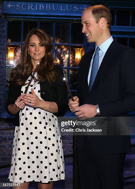 Catherine, Duchess of Cambridge and Prince William, Duke of Cambridge share a joke on the set used to depict Diagon Alley in the Harry Potter Films...