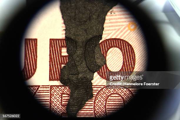 Burnt money, seen through a microscope, at the analysis lab of the German Bundesbank during a demonstration for the media on April 26, 2013 in Mainz,...