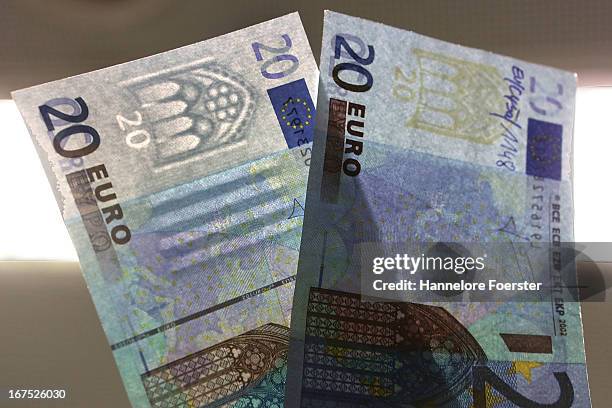 The difference between a real and a fake 20 Euro note, at the counterfeit money analysis lab of the German Bundesbank during a demonstration for the...