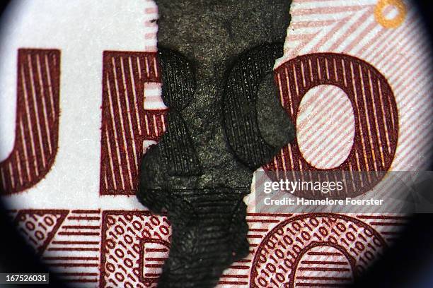 Burnt money, seen through a microscope, at the analysis lab of the German Bundesbank during a demonstration for the media on April 26, 2013 in Mainz,...