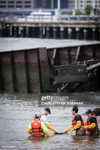 Britain's Prince William, Prince of Wales, examines oyster samples in the East River with students from the Urban Assembly New York Harbor School as...