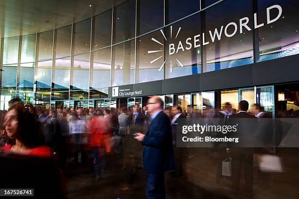 Visitors enter and exit the main entrance during the Baselworld watch fair in Basel, Switzerland, on Thursday, April 25, 2013. The annual fair...