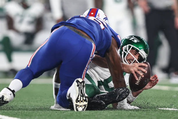 Aaron Rodgers of the New York Jets reacts as he sacked by Leonard Floyd of the Buffalo Bills during a game at MetLife Stadium on September 11, 2023...