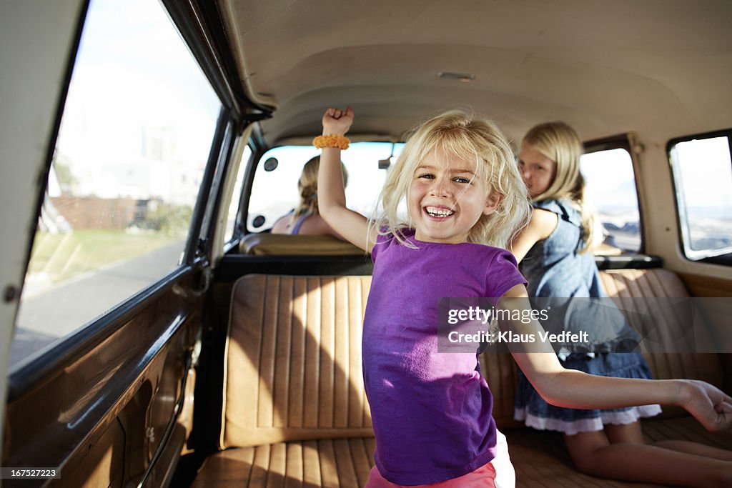 Cute girl dancing in back of old camper van