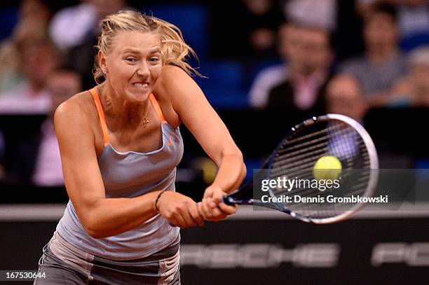 Maria Sharapova of Russia plays a backhand in her match against Ana Ivanovic of Serbia during Day 5 of the Porsche Tennis Grand Prix at Porsche-Arena...