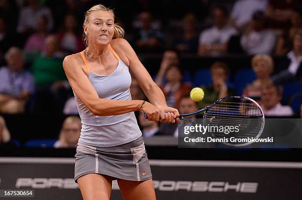 Maria Sharapova of Russia plays a backhand in her match against Ana Ivanovic of Serbia during Day 5 of the Porsche Tennis Grand Prix at Porsche-Arena...