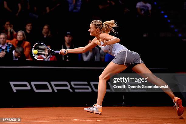 Maria Sharapova of Russia plays a forehand in her match against Ana Ivanovic of Serbia during Day 5 of the Porsche Tennis Grand Prix at Porsche-Arena...