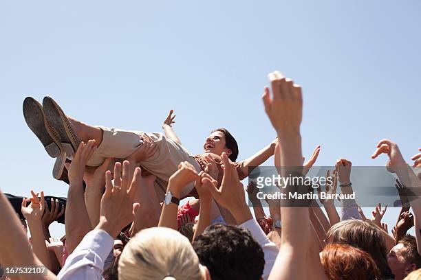 woman crowd surfing - crowdsurfing stock pictures, royalty-free photos & images