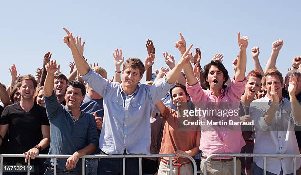 cheering crowd with arms raised - cheering stockfoto's en -beelden