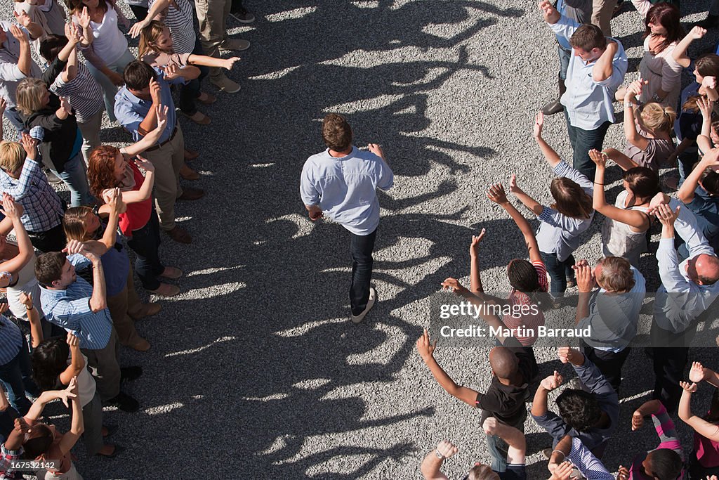 Man walking between two groups of people, elevated view