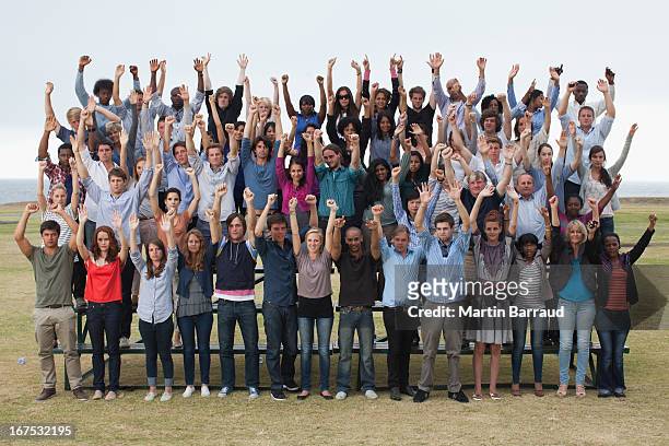 group of spectators cheering - cheering crowd stock pictures, royalty-free photos & images