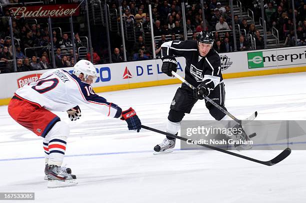 Rob Scuderi of the Los Angeles Kings passes the puck against Marian Gaborik of the Columbus Blue Jackets at Staples Center on April 18, 2013 in Los...
