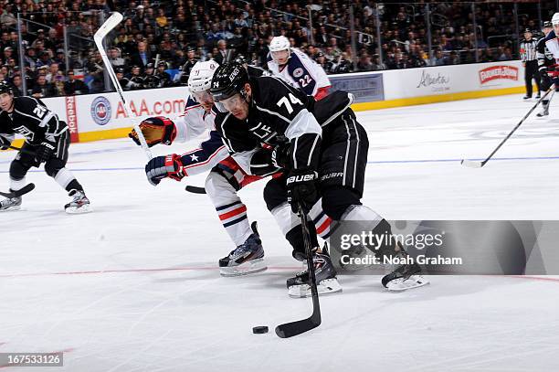 Dwight King of the Los Angeles Kings skates with the puck against James Wisniewski of the Columbus Blue Jackets at Staples Center on April 18, 2013...