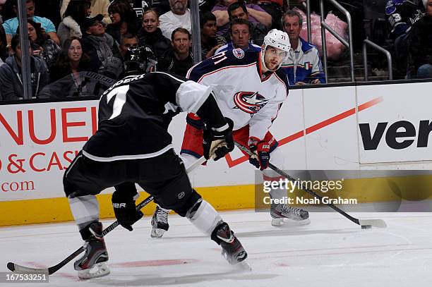 Nick Foligno of the Columbus Blue Jackets skates with the puck against Rob Scuderi of the Los Angeles Kings at Staples Center on April 18, 2013 in...