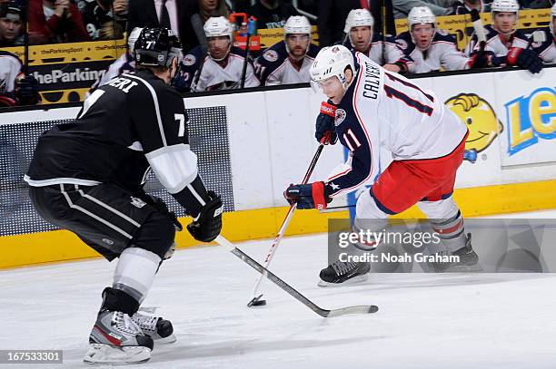 Matt Calvert of the Columbus Blue Jackets skates with the puck against Rob Scuderi of the Los Angeles Kings at Staples Center on April 18, 2013 in...
