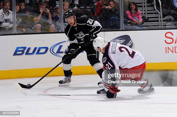Trevor Lewis of the Los Angeles Kings skates with the puck against James Wisniewski of the Columbus Blue Jackets at Staples Center on April 18, 2013...