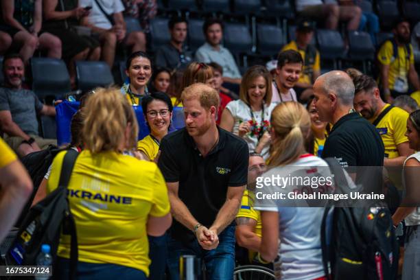Britain's Prince Harry, Duke of Sussex talks to Ukrainian fans during the Mixed Team Wheelchair Rugby match between the Team Unconquered and Team...
