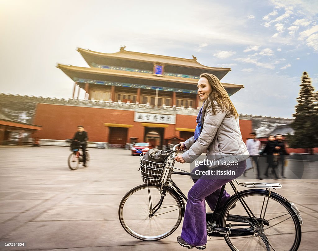 Tourist in Beijing riding bike