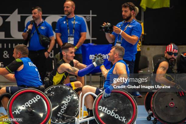 Veniamin Bondarchuk of Team Unconquered shakes hands of Team Italy competitor after the Mixed Team Wheelchair Rugby match during day one of the...