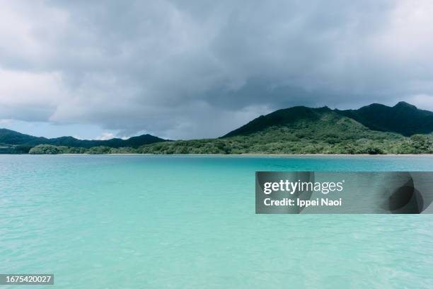 tropical lagoon with stormy clouds, ishigaki island, okinawa, japan - squall stock pictures, royalty-free photos & images