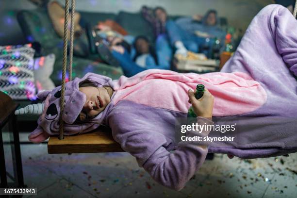 drunk woman resting on a home party. - passed out drunk stockfoto's en -beelden