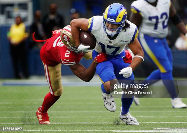 Los Angeles Rams wide receiver Puka Nacua churns downfield after a reception with San Francisco 49ers cornerback Deommodore Lenoir hanging on at SoFi...