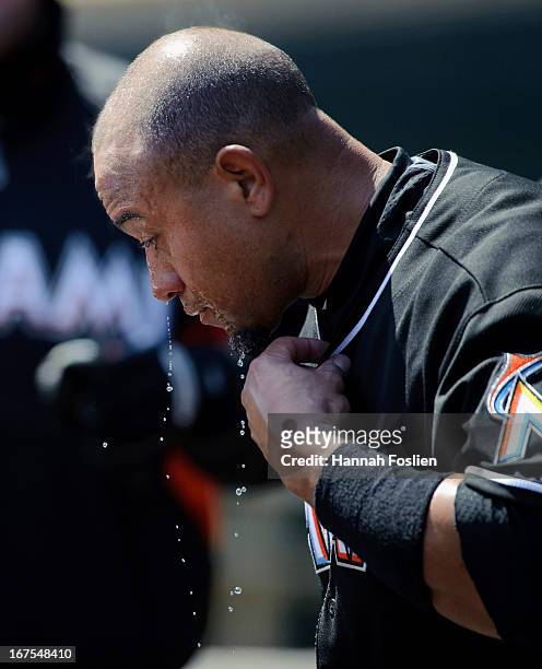 Miguel Olivo of the Miami Marlins pours water on his head in the dugout before the first game of a doubleheader against the Minnesota Twins on April...
