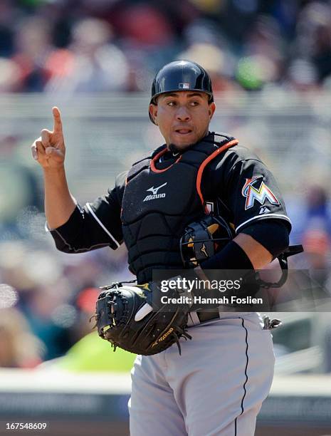 Miguel Olivo of the Miami Marlins shows signs while catching against the Minnesota Twins during the first game of a doubleheader on April 23, 2013 at...