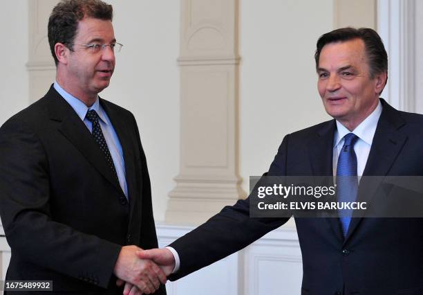 Chief Prosecutor of the International War crimes Tribunal in Hague, Serge Brammertz shakes hands with Chairman of Bosnia and Herzegovina's tripartite...