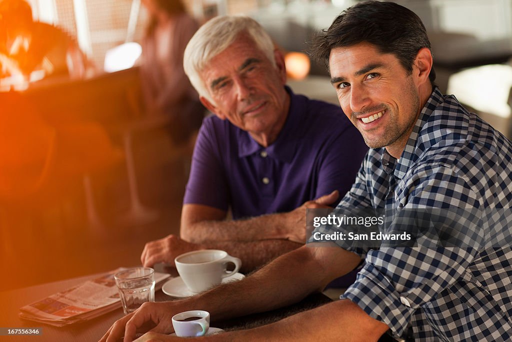 Men drinking coffee together in cafe