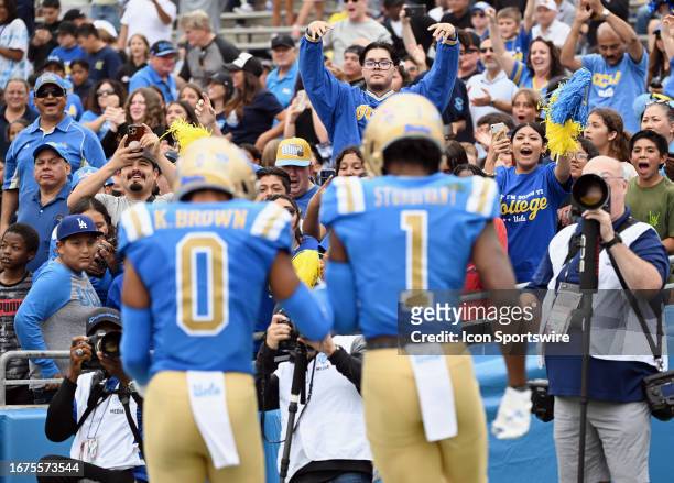 Fans in the stands cheering after UCLA Bruins wide receiver J. Michael Sturdivant caught a pass for a touchdown in the first half of an NCAA football...