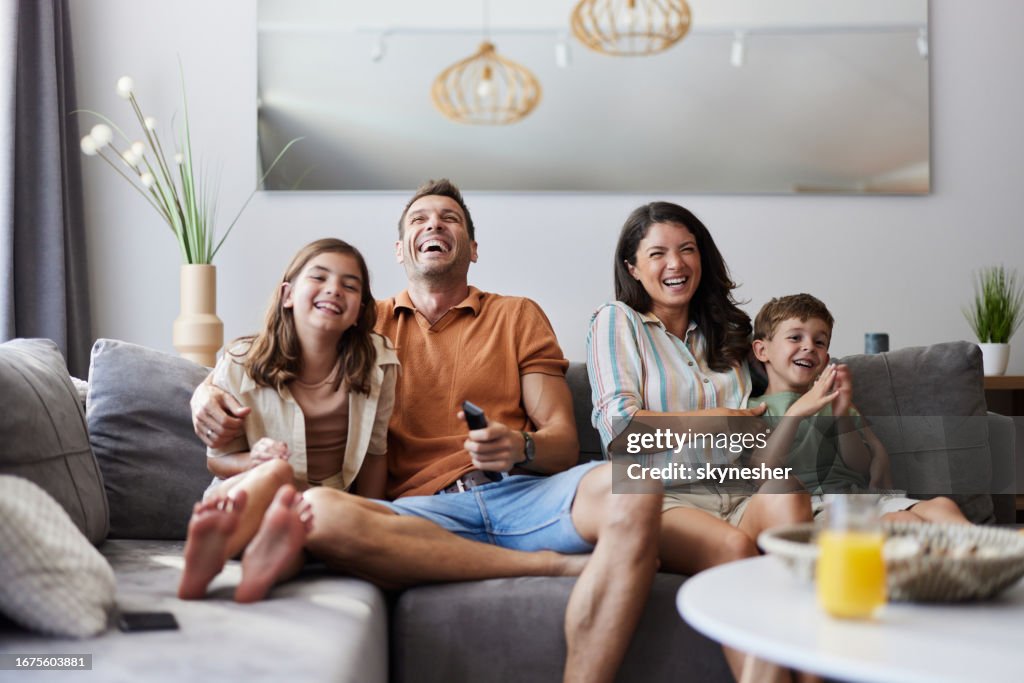 Cheerful family enjoying in a movie at home.