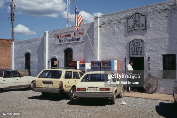 Exterior view of the the Plains Peanut Warehouse in President Jimmy Carter's hometown of Plains, Georgia, August 24th 1977. A placard on the wall...
