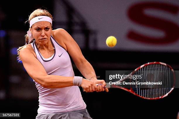 Sabine Lisicki of Germany plays a backhand in her match against Bethanie Mattek-Sands of the United States during Day 5 of the Porsche Tennis Grand...