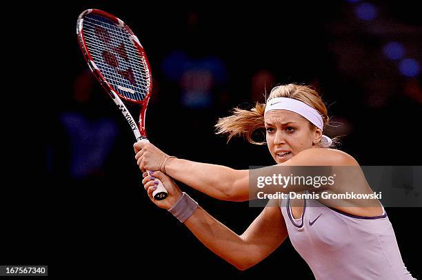 Sabine Lisicki of Germany plays a backhand in her match against Bethanie Mattek-Sands of the United States during Day 5 of the Porsche Tennis Grand...