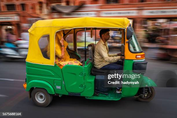 indian man drives auto rickshaw (tuk-tuk), india - rickshaw or tuk tuk or surrey or pedicab stock pictures, royalty-free photos & images