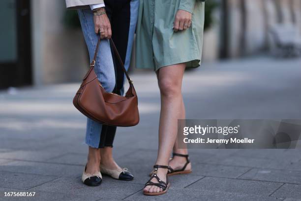Josephine Kröger wearing mint colored knee length long sleeve SoSue dress and black open Celine sandal with straps and Sue Giers wearing Celine bag,...