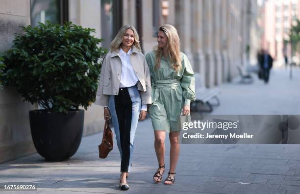 Josephine Kröger wearing mint colored knee length long sleeve SoSue dress and black open Celine sandal with straps and Sue Giers wearing Celine bag,...