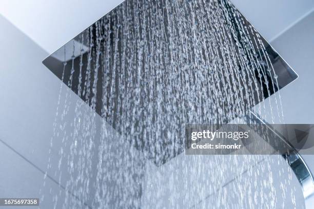 water flowing from shower head - shower head stock pictures, royalty-free photos & images